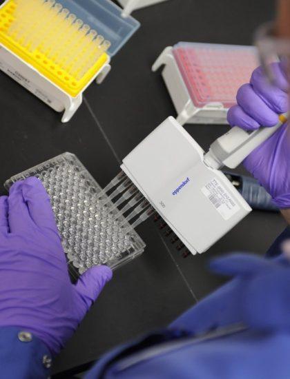 Scientist placing samples in vials